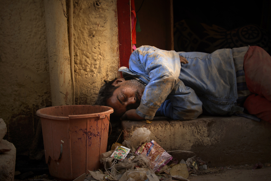 People with low wages and homeless are often been seen sleeping in the streets for the night. Lack of love and many other things can be the reasons for homelessness in India, which for centuries has caused families in India to have an average of five generations being homeless. In this photograph a man is sleeping on a stairway at Arakashan Rd in Delhi.