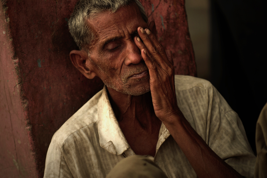 A photograph of an elderly Indian man with a hardened expression on his face was portrayed in Old Delhi, India. For the photographer these salient photographic moments offer some rare visages of India, a vast land that is most examined only through news reports of insurrection, poverty and famine. Rather than viewing the Indian culture as an indistinguishable whole, the photographer carefully focuses on the varied life journeys and life of the people he has encountered.