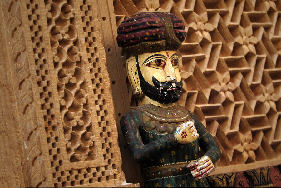 In this photograph a painted gateman has been photographed, a so-called 'Chowkidar', which is a traditional wood vintage statue from Rajasthan, India. It is folk art and Rajasthani handicraft wood, which is a handmade vintage style wood carved Indian watchman statue. Nowadays it can be one of the best way to gift your loved ones on any occasion and festivals.