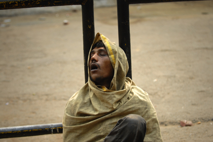 At the circle in Delhi the photographer caught this photo of a sleepy-eyed Indian man resting up against a steel fence at Connaught Place also known as 'Rajiv Chowk'. Read about the the place between the rich and the poor in this archive story.