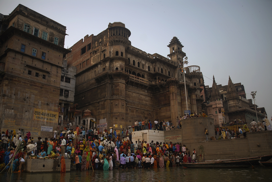 Devoted Hindus are gathered at the Rana Mahal Ghat in Varanasi, India a late afternoon. This 'Ghat' is located south of Dasaswamedh Ghat, between Darbhanga Ghat and Chousaiti Ghat along the Ganges in Varanasi. As you can see in this photograph 'Ghats' are embankments made in steps of stone slabs along the river bank where pilgrims perform ritual ablutions.