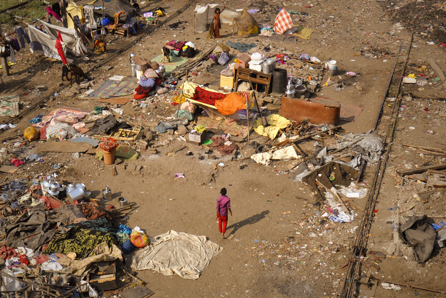 Slums in India are highly populated urban residential areas consisting of densely packed housing units of weak build quality and often associated with poverty. The infrastructure in slums is often deteriorated or incomplete and they are primarily inhabited by impoverished people as seen in this photograph from the Wadala area in Mumbai, India.