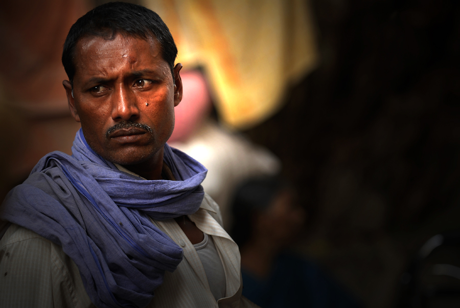 A street portrait just means a likeness of someone. For instance, you can photograph a full body portrait of someone and you can also shoot a closeup face portrait of someone. Anyways, the photographer personally always been drawn and attracted to faces like with this street portrait of an Indian man in Varanasi.